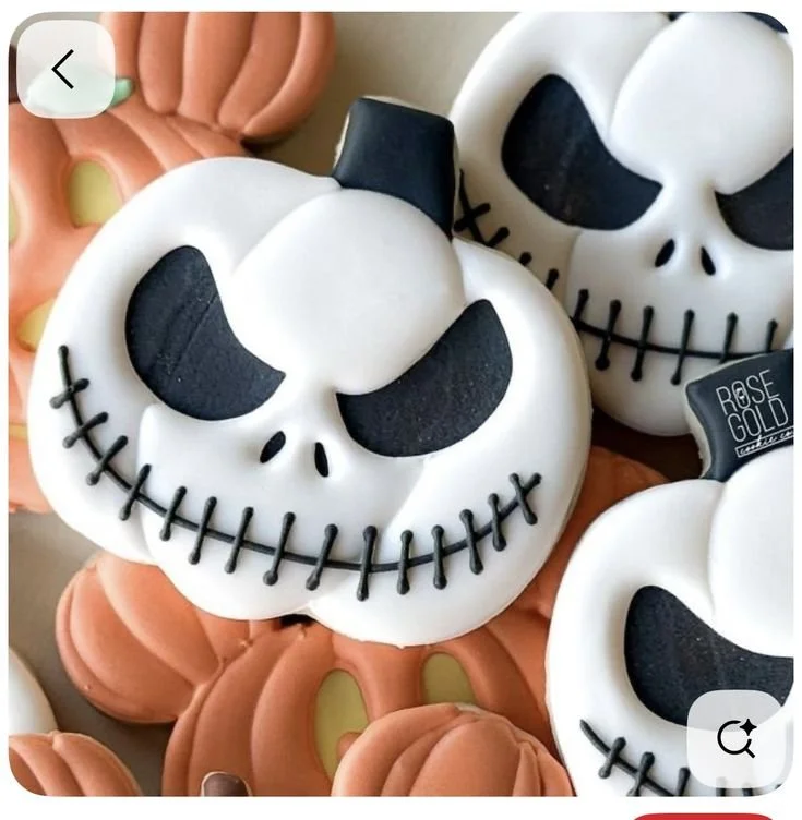 Halloween cookies featuring Jack Skellington and Sally designs with royal icing