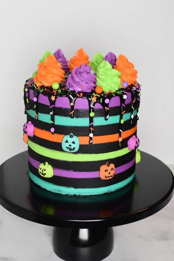 Colorful Halloween rainbow cake with festive decorations and spooky designs