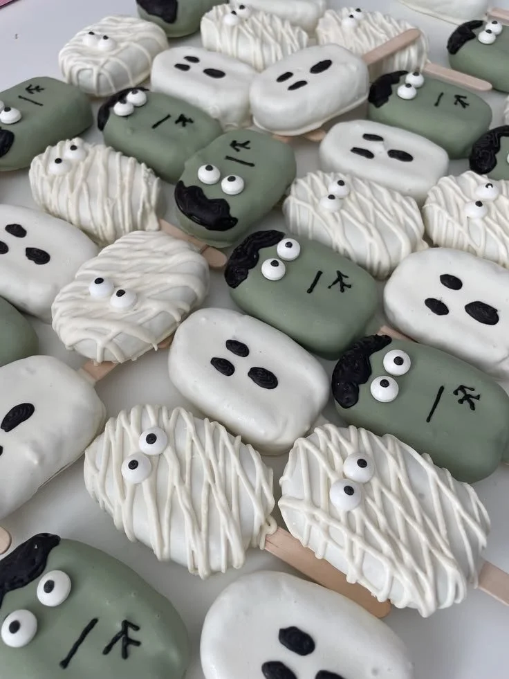 Assorted Halloween treats including cake pops and chocolate covered Oreos.