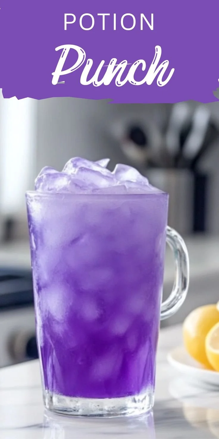 Colorful Potion Punch in a crystal bowl with fruit garnishes.