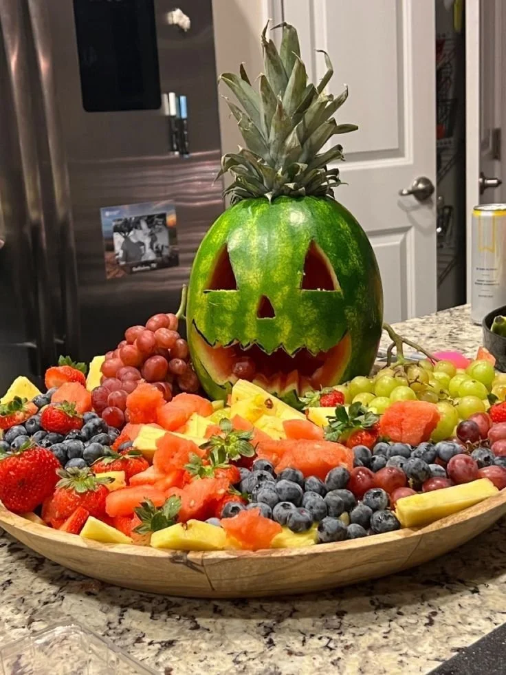 Spooky fruit tray with Halloween-themed fruit decorations