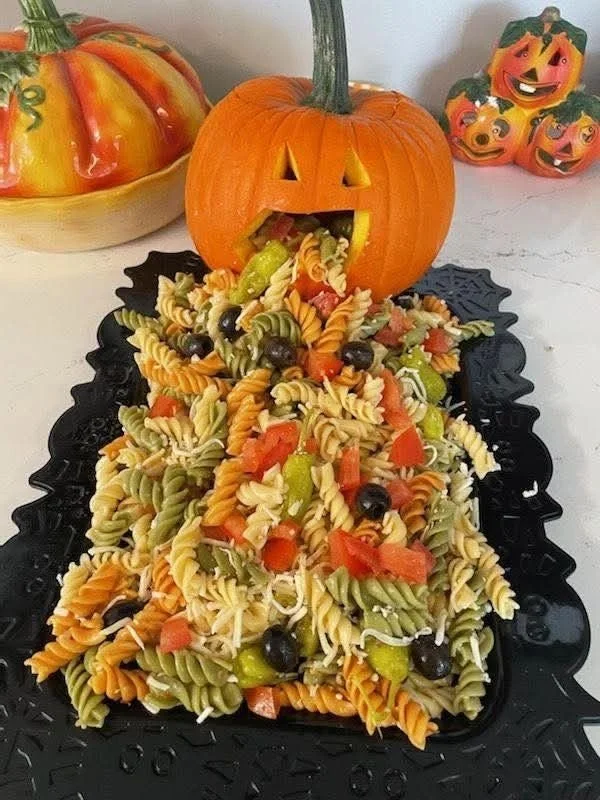 Colorful spooky Halloween pasta salad with vegetables and turkey, perfect for parties