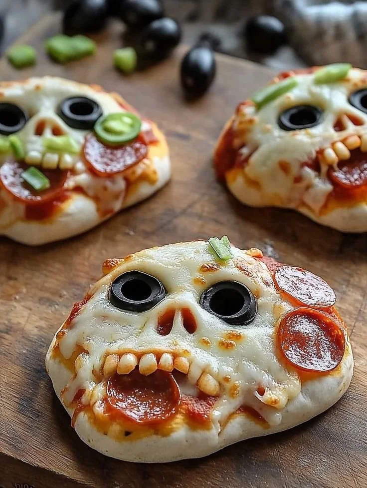 Halloween pizza with skull shapes and stuffed designs for spooky baking fun