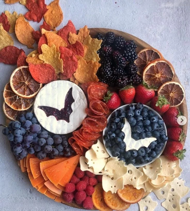 Trader Joe's Halloween charcuterie board featuring spooky treats and fruit.